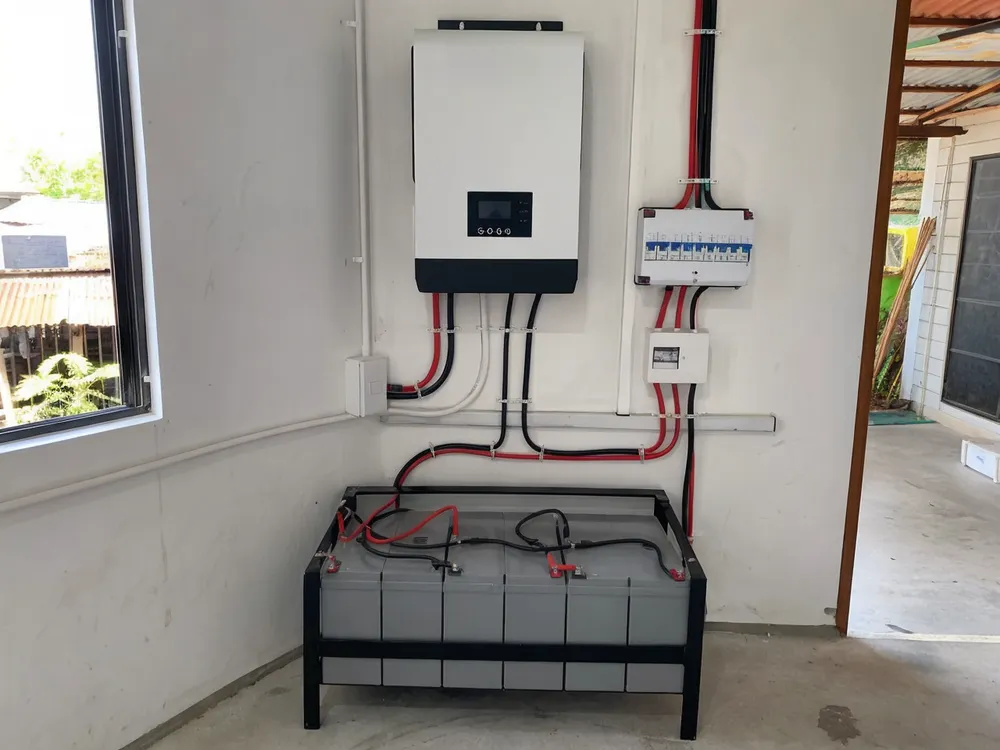 24V solar battery system installed in a mid-size solar home kit showing cable routing and inverter connection