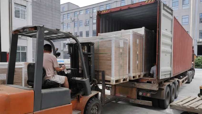 Commercial solar battery modules palletized and loaded into shipping container with reinforced packaging
