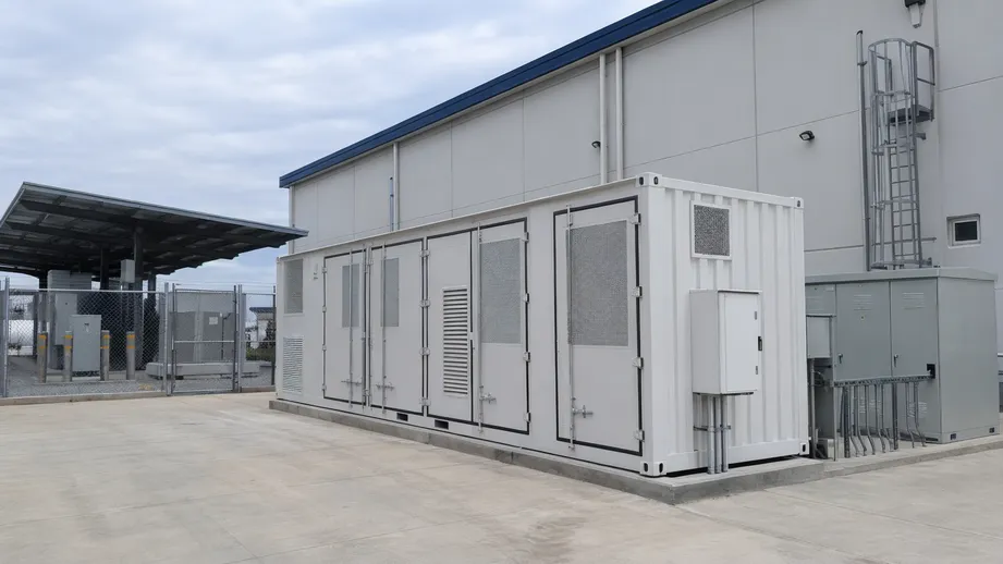 Container battery storage installed outside a commercial warehouse for peak demand shaving