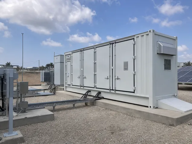 Containerized battery storage deployed at an outdoor industrial site without existing battery room