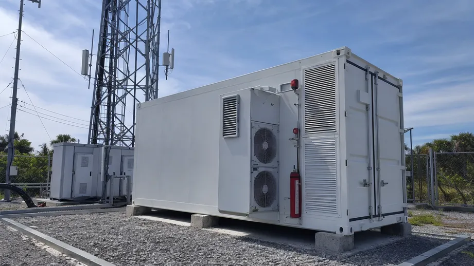 Container battery storage supporting telecom base station with integrated HVAC and fire suppression